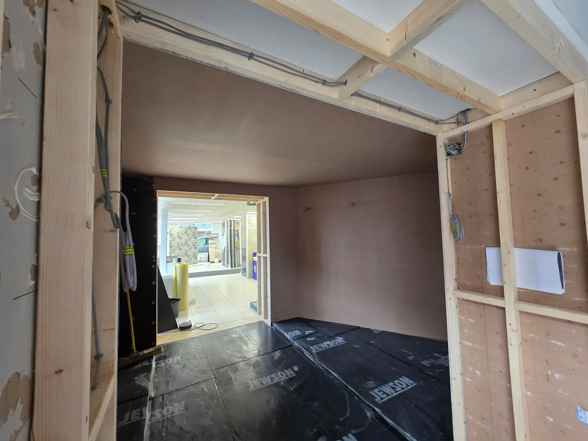 Plasterboard fixed across an internal wall, joints ready for taping and skimming.