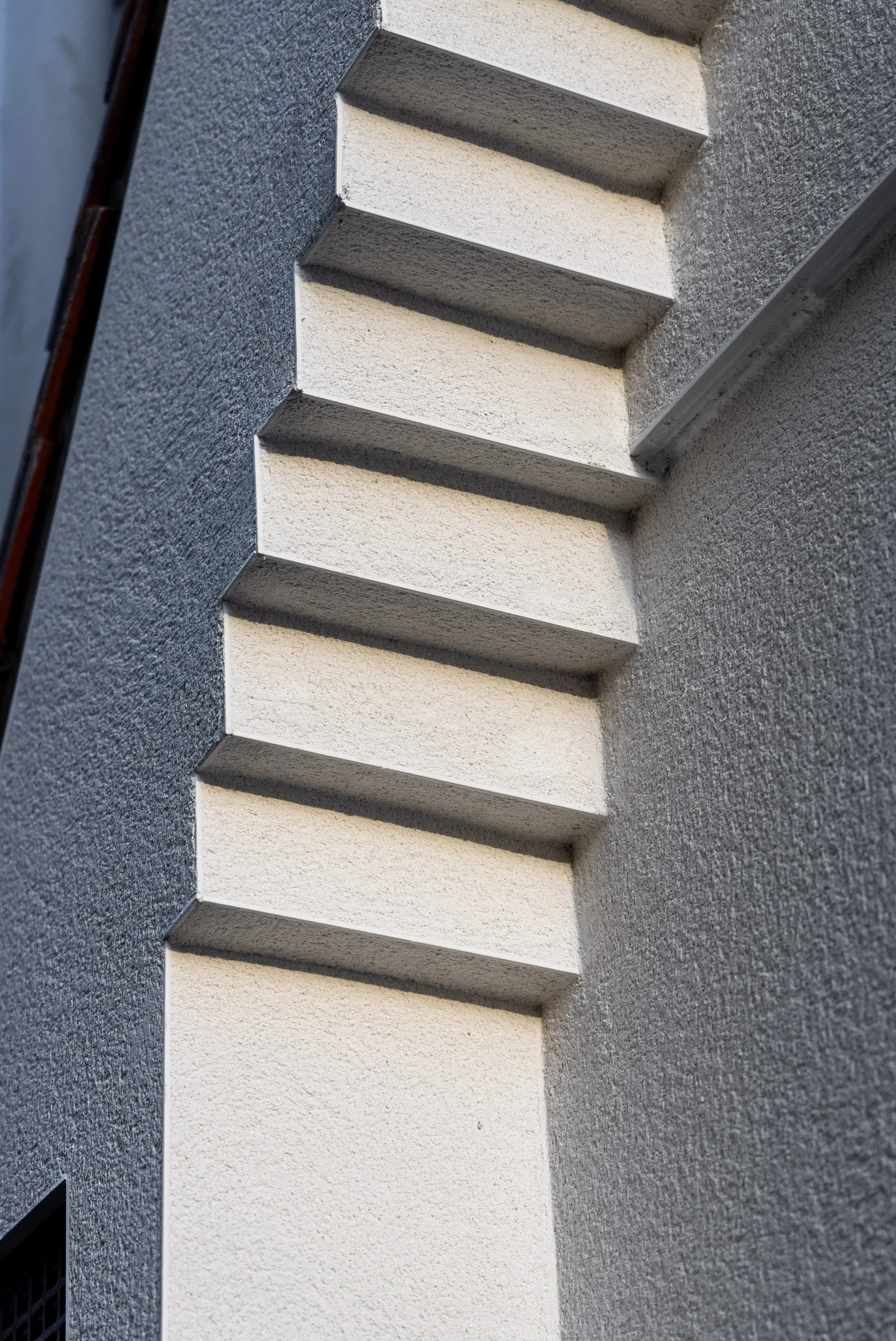 A flight of external steps finished in render, each tread and riser crisply formed.